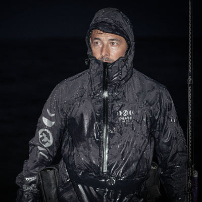 Person wearing a black sECLIPSE Fishing top in rough weather conditions